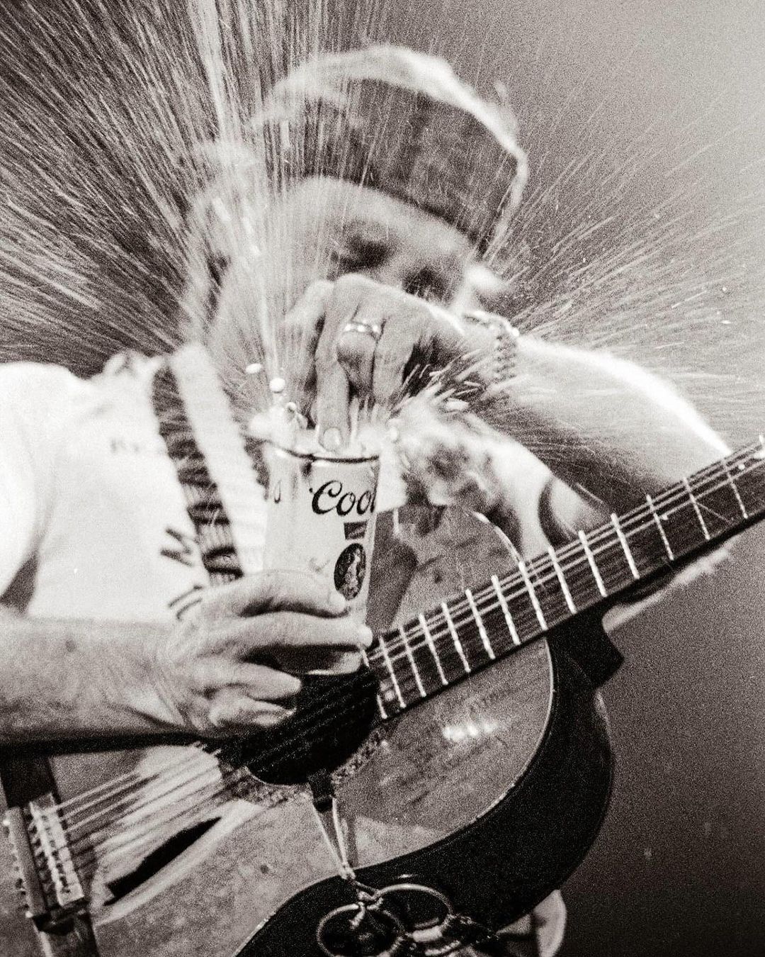 Willie Nelson Cracking Open A Coors Beer can holding his guitar