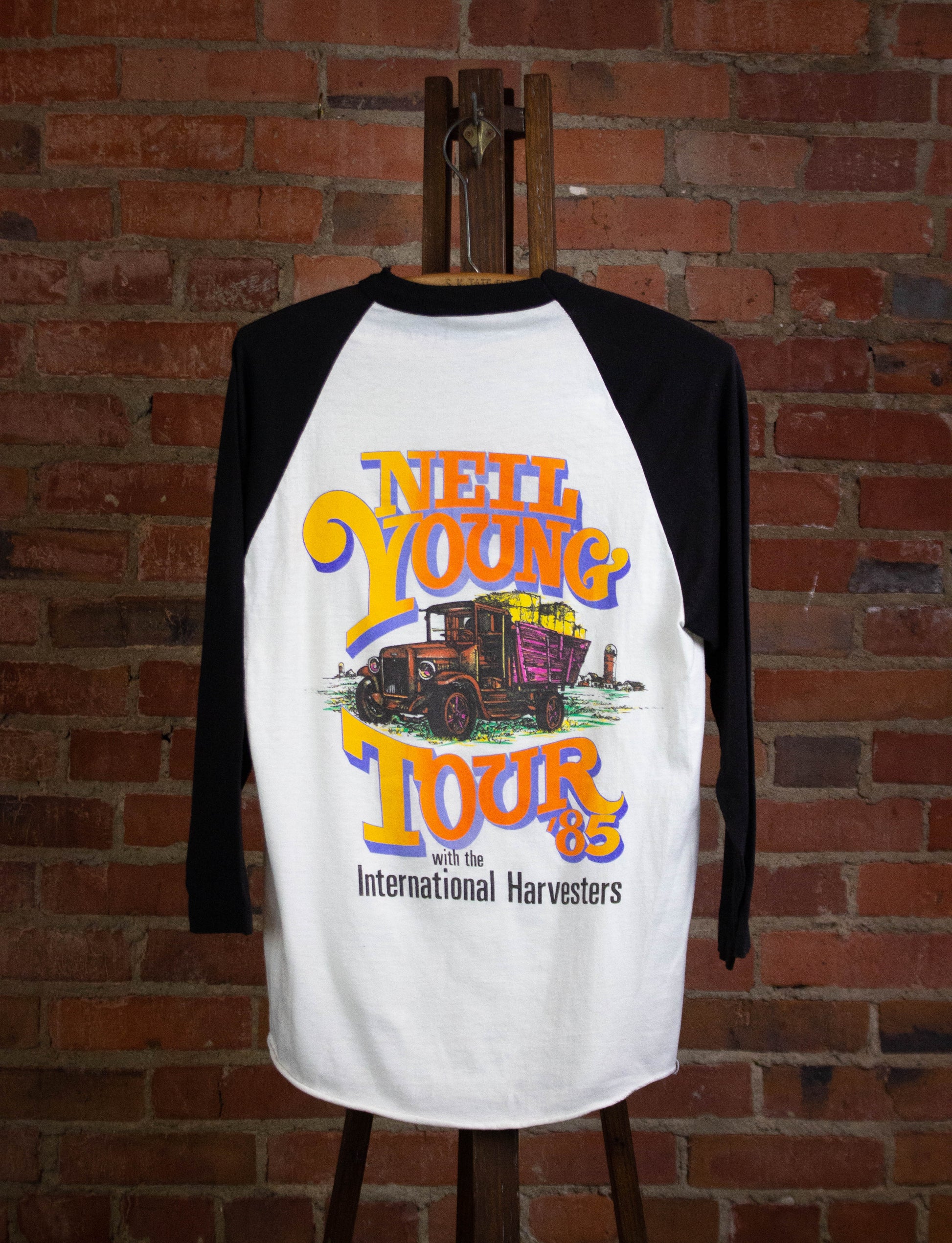 Vintage Neil Young with the International Harvesters 1985 Tour Raglan Concert T Shirt White and Black Medium