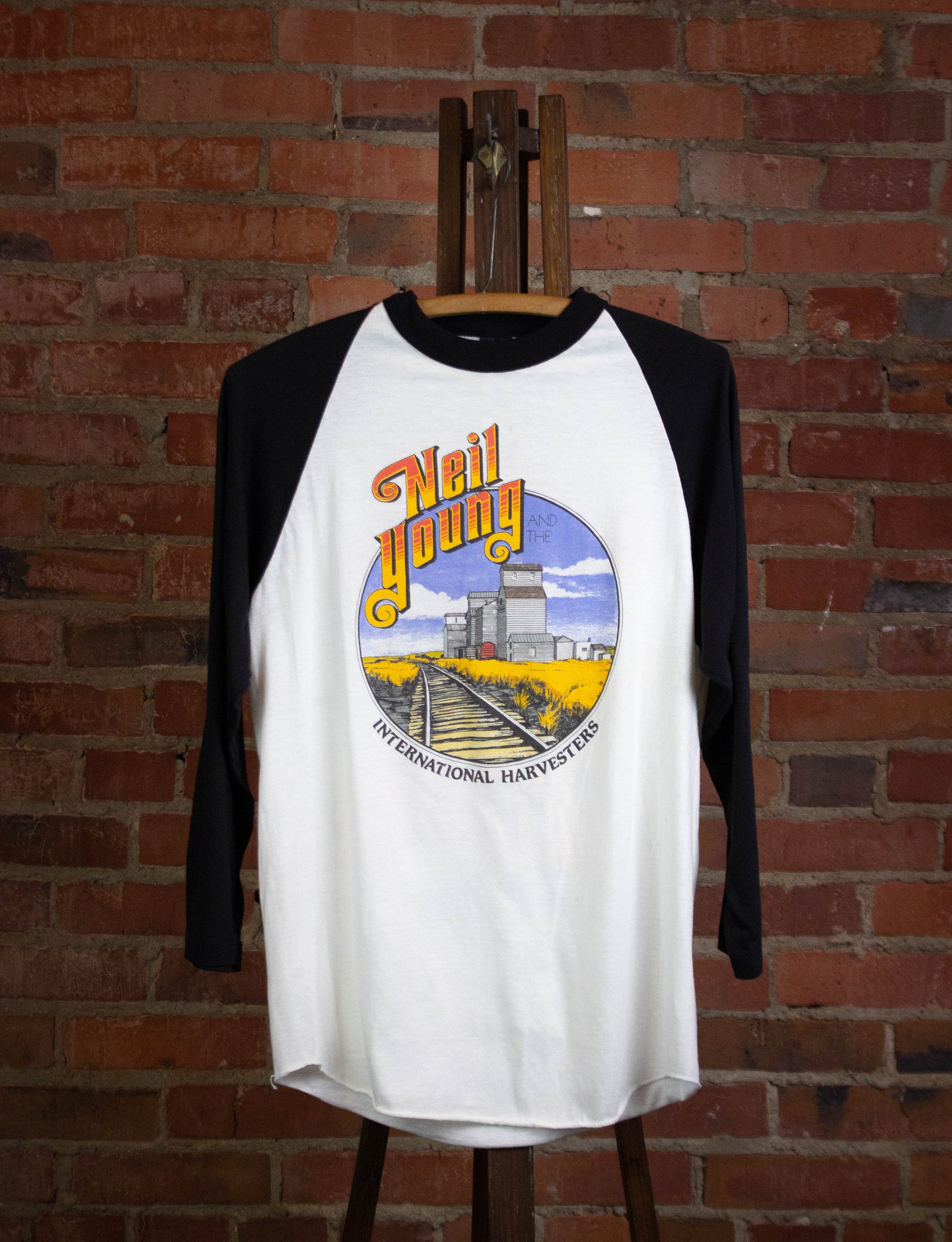 Vintage Neil Young with the International Harvesters 1985 Tour Raglan Concert T Shirt White and Black Medium
